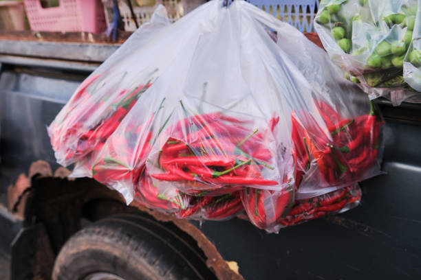 Red chilli in a plastic bag, hung beside the car
