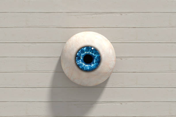 istock Blue eye staring from white wooden wall background 2162994664