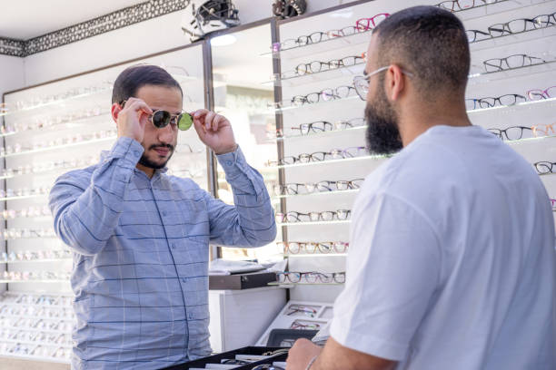 istock Male selecting the best eyeglasses, also selecting sunglasses whihc is clips eyeglasses 2162996120