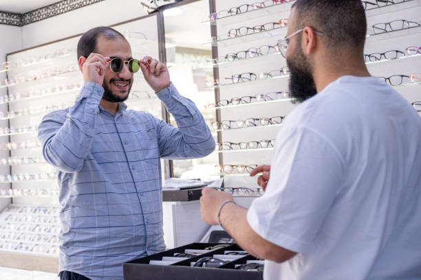 istock Male selecting the best eyeglasses, also selecting sunglasses whihc is clips eyeglasses 2162996146