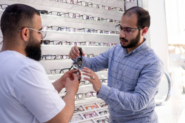 istock Male selecting the best eyeglasses, also selecting sunglasses whihc is clips eyeglasses 2162996219