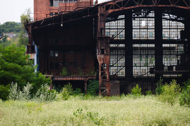 istock Overgrown Industrial Ruins with Lush Vegetation 2162998135