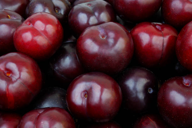 istock Ripe purple plums background 2162998481