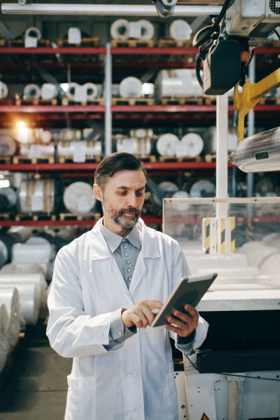 istock Engineer with tablet working at polymer factory warehouse 2162999526