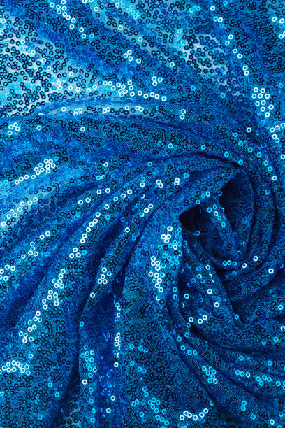 istock Light blue abstract spiral textile. satin luxury cloth. blue sequins background 2163000292