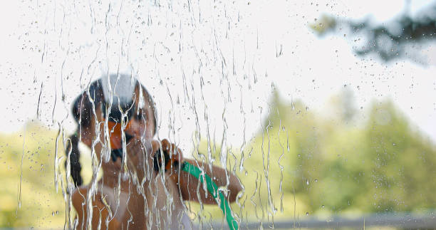 istock the girl cleaning the balcony window 2163000539