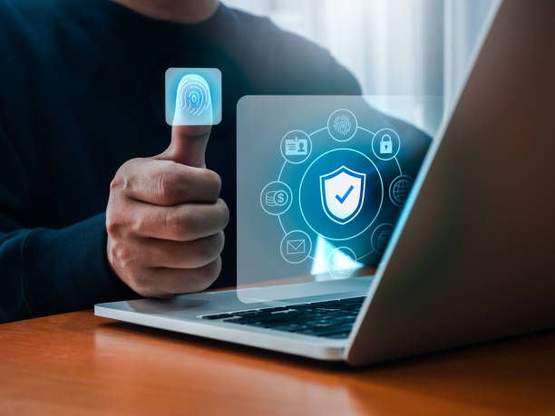 istock Fingerprint scan access tech on businessman thumb, biometrics identification while personal data element icons show on laptop screen. Cyber security, privacy data protection technology for business. 2163000836