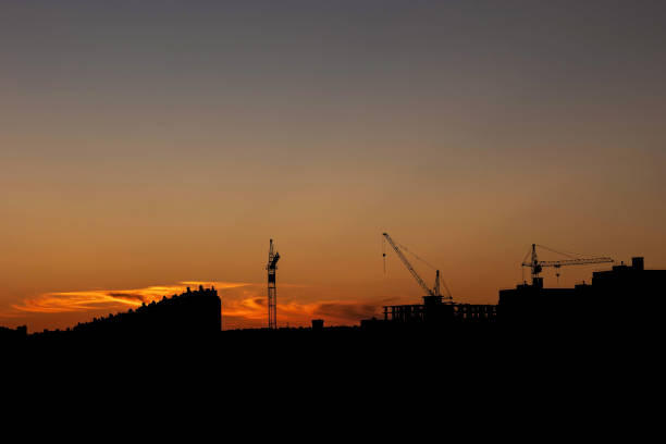 istock construction cranes on the background of the sunset sky 2163001058