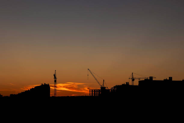 construction cranes on the background of the sunset sky
