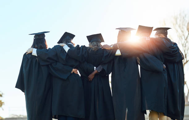istock People, group row and  graduation for education at university, together with back hug for achievement. Graduate, college and campus with solidarity for academic goal, students with bright future 2163001899