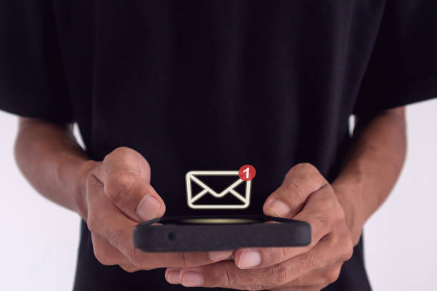 istock Man holding a smartphone with email notification, new message or social media notification. 2163003413