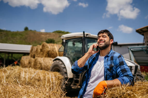 istock Man farmer standing in front of tractor 2163004561