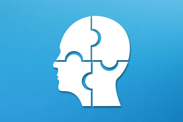 istock Head made of white jigsaw puzzle four pieces on blue background 2163005427