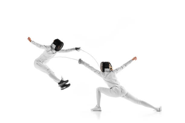 istock In dynamic training session, two female fencers clash swords, each testing other's defenses against white studio background. 2163005775