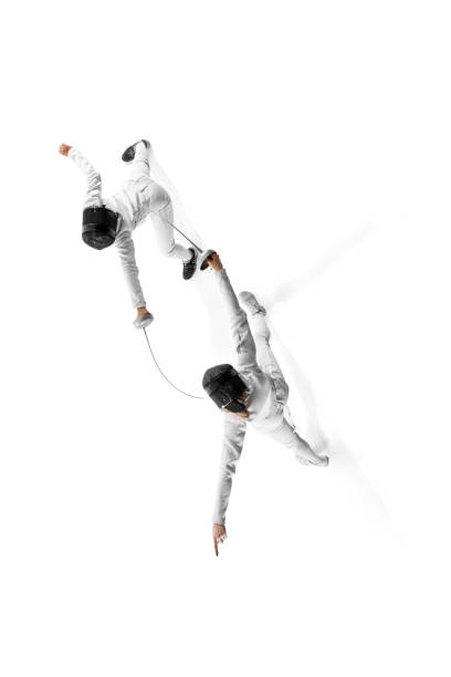 istock Poster. Practicing for competition, two female fencers clash swords in intense training session against white studio background. 2163005784