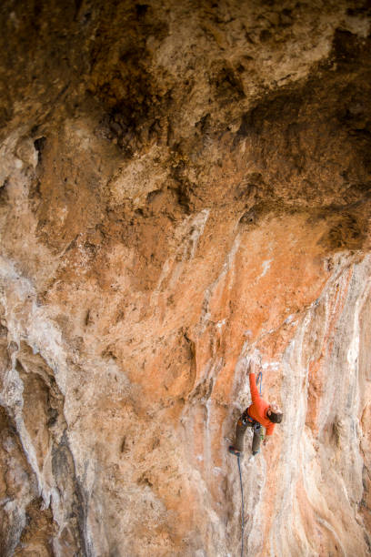 istock A rock climber climbs to the top along a difficult route. 2163005932
