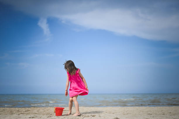 girl picking up sea shells