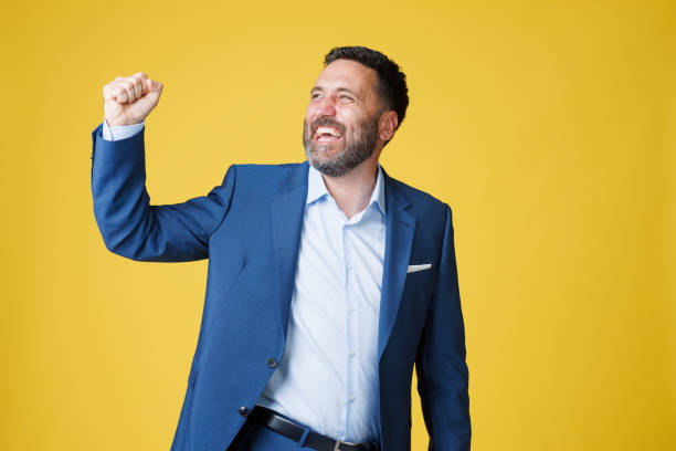 istock Dynamic Portrait handsome man.  Elegance Blue well-dressed  businessman,  Yellow background. 2163009841