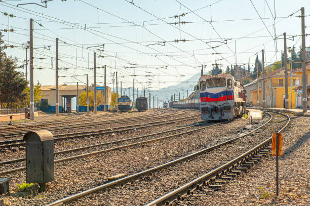 Empty railway tracks with railroad switch seen from above. The railway tracks create an almost abstract line pattern from this high viewpoint.