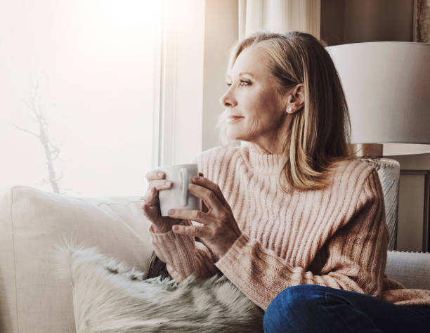 istock Old woman, thinking and calm tea in home, relax and hot beverage to remember memory on weekend. Female person, espresso and planning for retirement in living room, wondering and coffee for comfort 2163010599