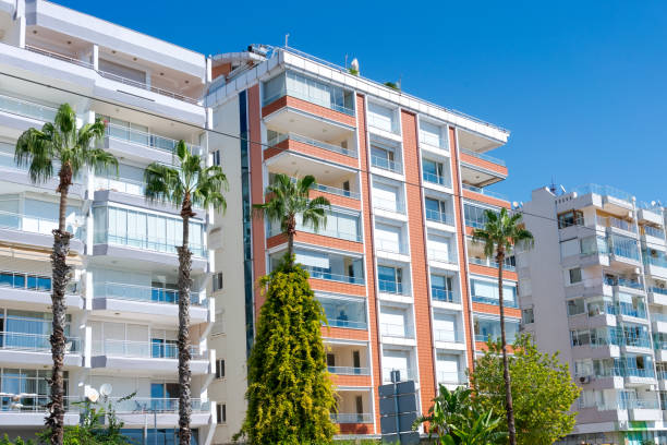 istock Modern apartment buildings with palm trees on a sunny day. 2163011413