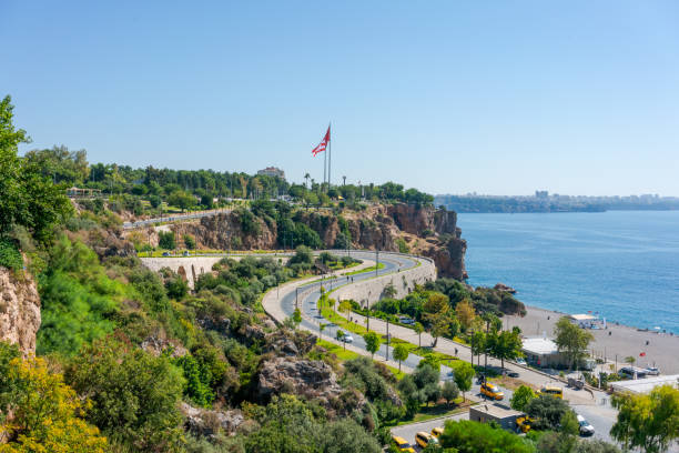 istock Scenic coastal road with lush greenery and ocean view on a sunny day. 2163011414