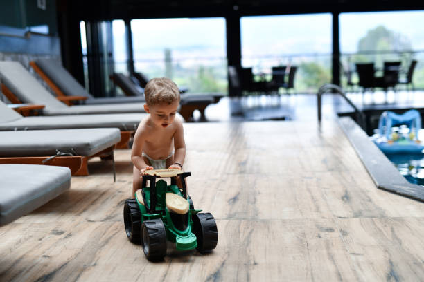 Swimming Pool Deck Fun For Toddler With Toy Tractor