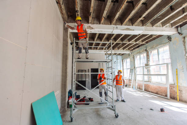 istock Team of workers setting up scaffold in a construction site 2163011975