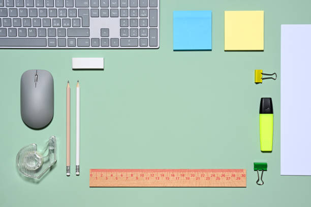 Office items on green background, flat lay