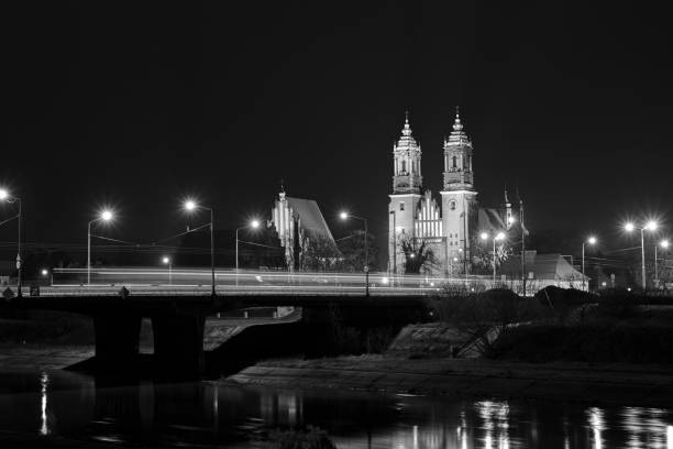 bridge over the river Warta and gothic cathedral at night in Poznan, Poland