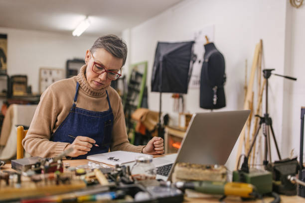 istock Person working on jewelry in a cozy workshop 2163016555