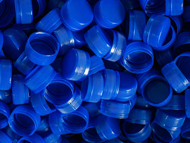 istock Top view blue plastic bottle caps.Recycling collection and production processing plastic bottle caps background ,Industrial production of bottle caps made of blue high-density polyethylene. 2163016852