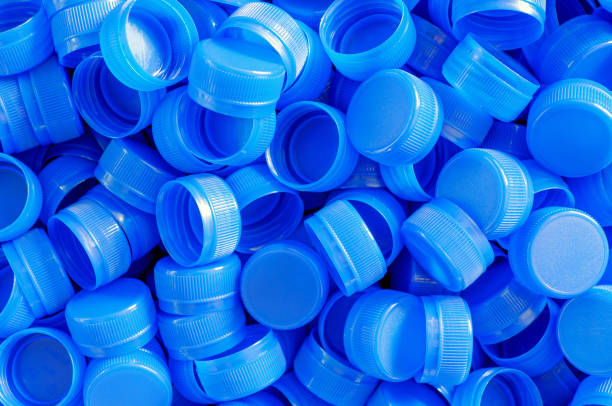 istock Top view blue plastic bottle caps.Recycling collection and production processing plastic bottle caps background ,Industrial production of bottle caps made of blue high-density polyethylene. 2163016896