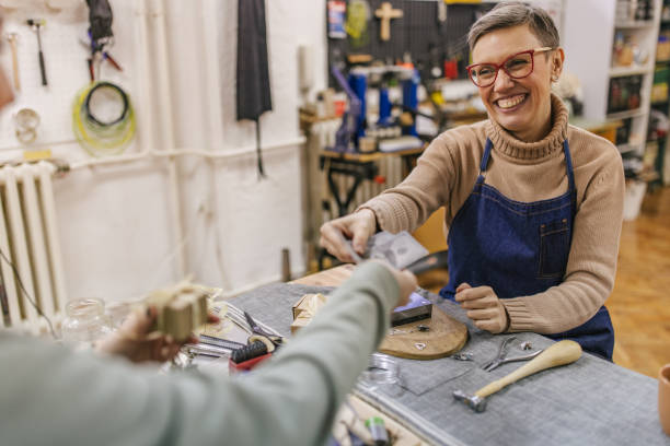 istock Person paying for a purchase in a creative jewelry workshop setting 2163017559