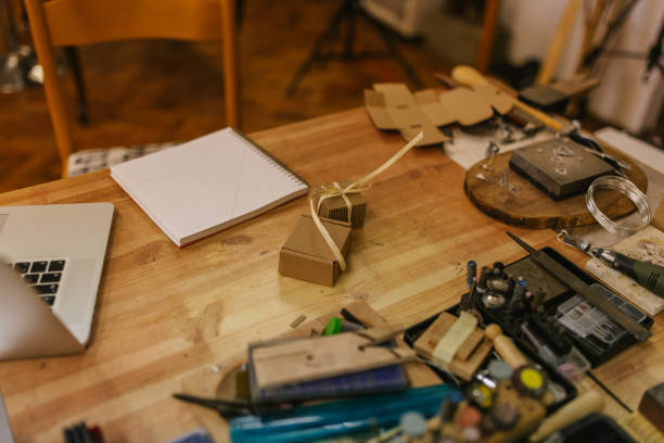 istock Jeweller workspace with notebook and tools, viewed from above. 2163019059