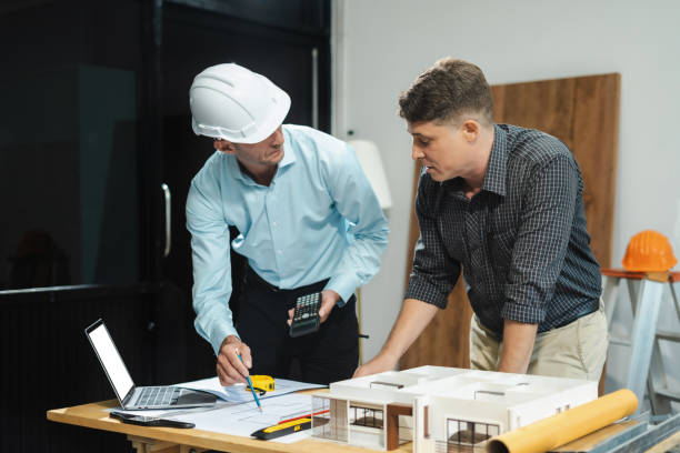istock Architect caucasian man working, blueprint meeting for project working with partner on model building at company office. 2163019128