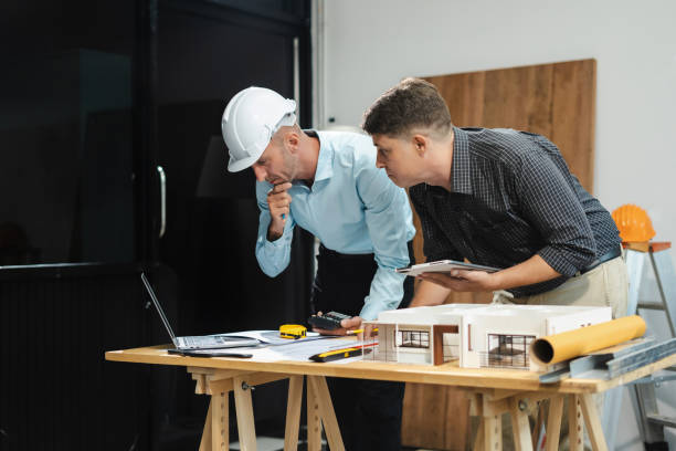 istock Architect caucasian man working, blueprint meeting for project working with partner on model building at company office. 2163019129