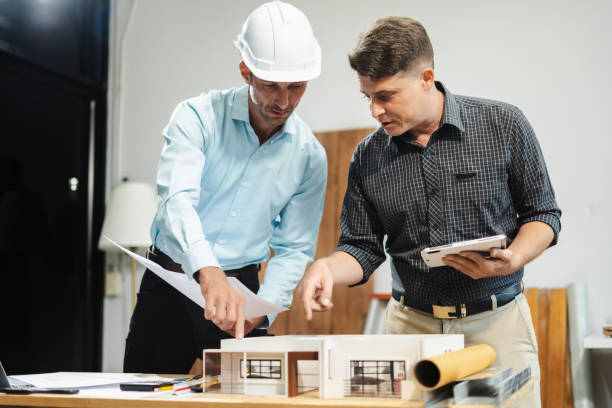 istock Architect caucasian man working, blueprint meeting for project working with partner on model building at company office. 2163019150