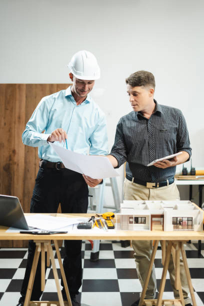 istock Architect caucasian man working, blueprint meeting for project working with partner on model building at company office. 2163019153