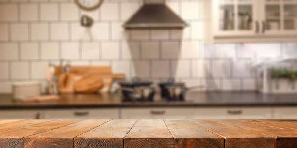 istock Empty wooden table with copy space for products. Blurred bright kitchen interior background. 2163020527