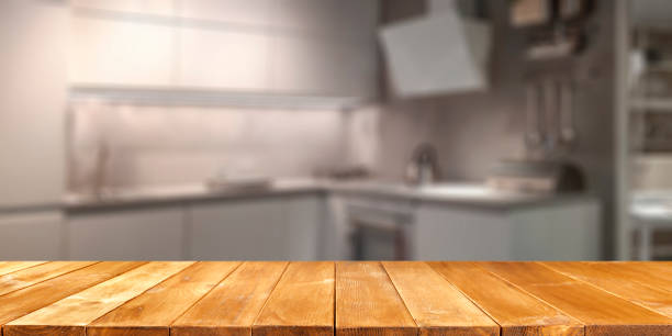 istock Empty wooden table with copy space for products. Blurred bright kitchen interior background. 2163020565