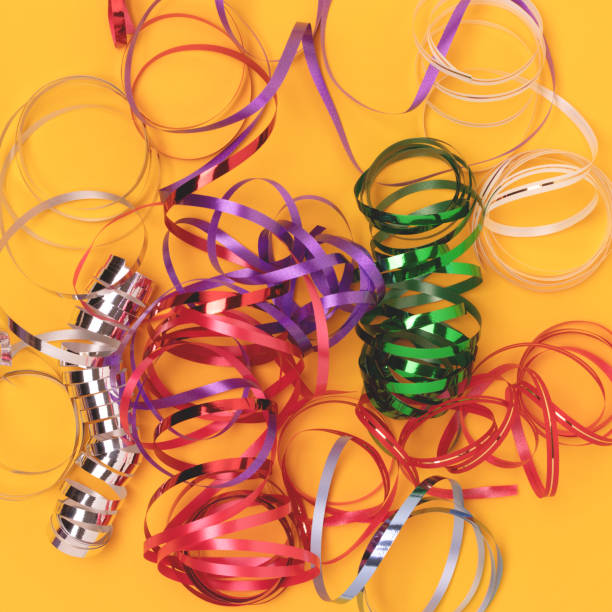 istock Multicolored ribbons on a yellow background. 2163021619