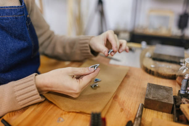 istock Hands working on small jewelry pieces on a workshop table. 2163022642