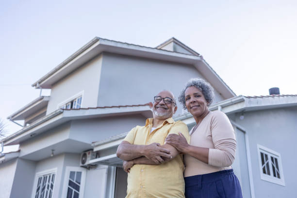 istock Latin couple lovingly embracing in front of their home 2163024925