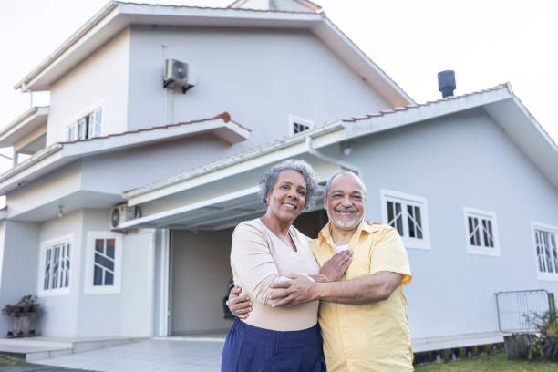 istock Latin couple lovingly embracing in front of their home 2163024933
