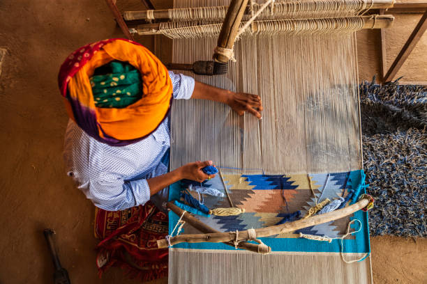 istock Indian man weaving textiles (durry) in Rajasthan 2163025365