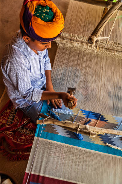 istock Indian man weaving textiles (durry) in Rajasthan 2163025388