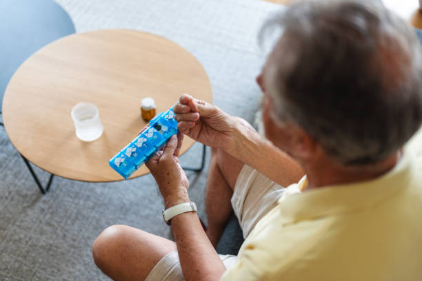istock Caucasian Senior Man Organizing Pills at Home 2163025509