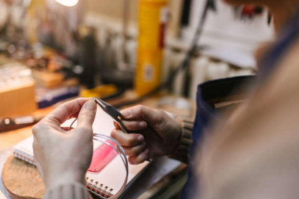 istock Close up on hands making jewelry 2163025941