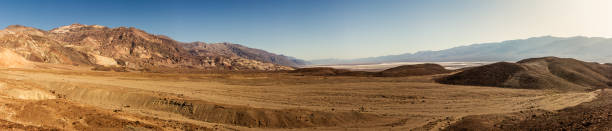 Sandy desert plain with rocky mountains witout life in Death Valley at sunny day, america Sandy desert plain with rocky mountains witout life in Death Valley in america at sunny day, usa witout stock pictures, royalty-free photos & images